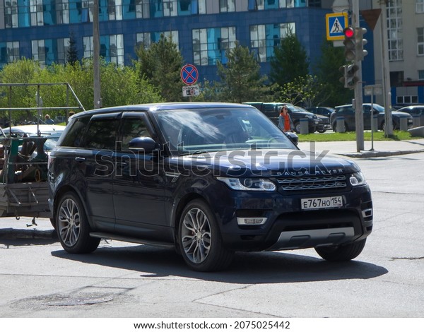 Novosibirsk, Russia, may 14 2020: private 4wd awd\
all-wheel drive dark blue black metallic color  british frame\
crossover Land Rover Range Rover Sport L494 luxury SUV made in UK\
on sunny urban\
street