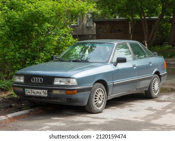 Novosibirsk, Russia, may 15 2021: private used  compact blue gray metallic color germany sedan Audi 90 B3, old classic vintage 90s luxury car from Kazakhstan parking on city urban summer yard street 