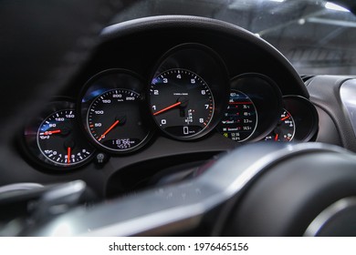 Novosibirsk, Russia - May 16, 2021: Porsche Cayenne, New Car Interior Details. Speedometer, Tachometer And Steering Wheel