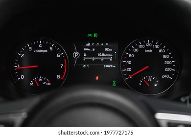 Novosibirsk, Russia - May 16, 2021: Kia Sportage, Speedometer, tachometer and steering wheelspeedometer of a modern car with an integrated fuel gauge in the tank with white arrows. 
