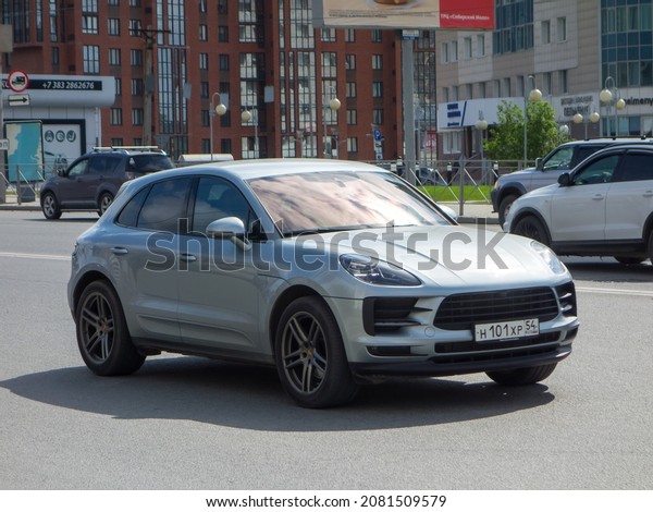Novosibirsk, Russia, may 17 2021: private\
all-wheel drive silver blue metallic color compact sport fast coupe\
crossover Porsche Macan 95B, made in Germany luxury awd 4wd SUV car\
on urban city\
street
