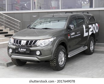 Novosibirsk, Russia - may 18 2018: private brown metallic color japanese thai pick-up truck car SUV Mitsubishi L200 Triton, frame crossover import export made in Thailand driving city urban street