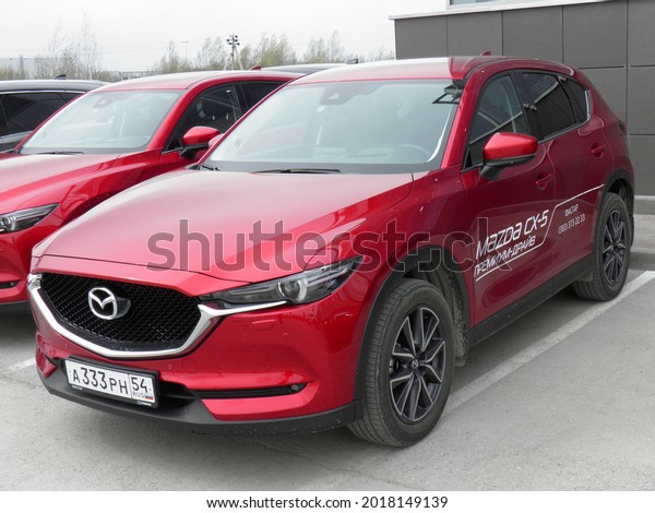 Novosibirsk, Russia - may 18 2018: private awd\
all-wheel drive red metallic color japanese midsize small SUV Mazda\
CX-5 Skyaktiv, popular car crossover parking in area, show dealer\
exhibition copy