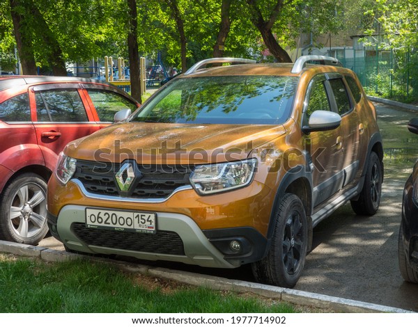 Novosibirsk, Russia - may 18 2021: private awd\
all-wheel drive orange  metallic color franch romanian crossover\
4x4 4wd Renault Duster Edition One II generation, new car SUV\
parking in summer\
yard