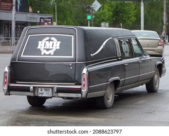 Novosibirsk, Russia, May 19 2021: Black Metallic Color American Old Classic Vintage Station Wagon Car Based On Chassis 80s 90s Cadillac De Ville, Service Hearse Funeral Cortege, Driving On City Street