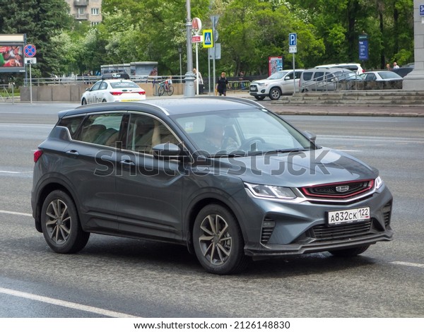 Novosibirsk, Russia, may 19 2021: private\
all-wheel drive dark gray grey metallic crazy color chinese family\
midsize SUV Geely Coolray SX11 new car crossover made in China\
drive on broad urban\
street