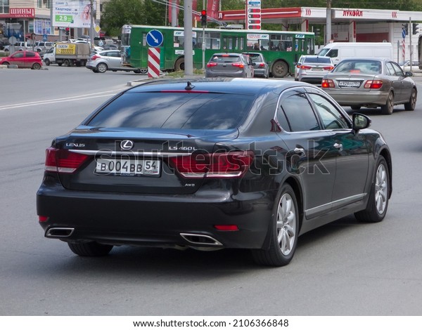 Novosibirsk, Russia - may 20 2021: private black\
metallic used 2000s 00s japanese AWD all wheel drive car Lexus LS\
460 L facelift, midsize sport sedan made in Japan drive on urban\
broad city street
