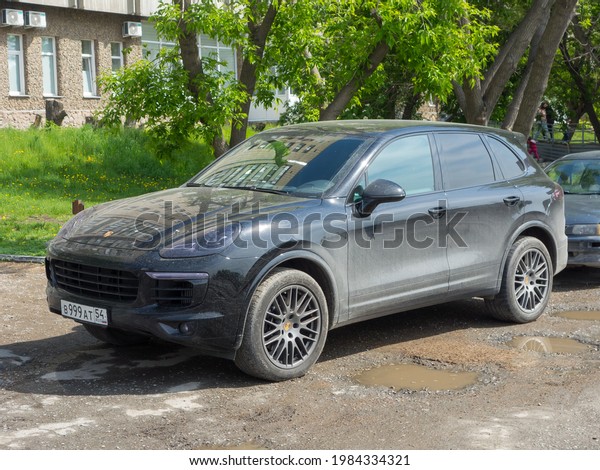 Novosibirsk, Russia - may 24 2021: private awd\
all-wheel 4wd 4x4 drive black metallic color germany sport coupe\
crossover new Porsche Cayenne (958), luxury car SUV 4wd parking on\
city urban street