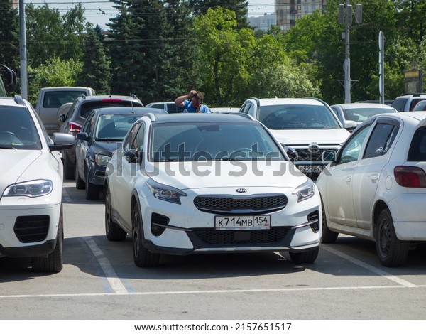 Novosibirsk, Russia - may 25 2021: private 4wd awd\
all-wheel drive white metallic South Korean midsize hatch SUV KIA\
Xceed (Ceed), model of 2019 crossover, free parking on city urban\
public street 