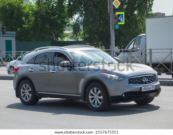 Novosibirsk, Russia, may 28 2021: private awd\
all-wheel 4wd 4x4 drive gray metallic color japanese sport coupe\
crossover used Infiniti FX35 QX70 luxury car SUV 4wd driving on\
city urban sunny\
street