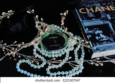 Novosibirsk, Russia- November 05, 2018 : Chanel Perfume In The Style Of Magazine Shooting With  A String Of Pearls And A Book                               