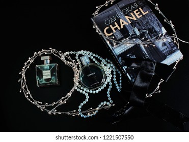 Novosibirsk, Russia- November 05, 2018 : Chanel Perfume In The Style Of Magazine Shooting With  A String Of Pearls And A Book                               