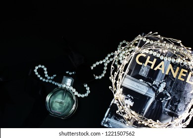 Novosibirsk, Russia- November 05, 2018 : Chanel Perfume In The Style Of Magazine Shooting With  A String Of Pearls And A Book                               