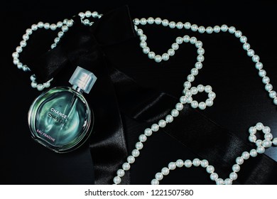 Novosibirsk, Russia- November 05, 2018 : Chanel Perfume In The Style Of Magazine Shooting With  A String Of Pearls And A Book                               