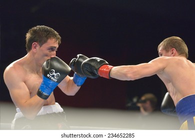 NOVOSIBIRSK, RUSSIA - NOVEMBER 29, 2014: Match Boris Georgiev (left) Of Bulgaria Vs Viacheslav Kislitsyn Of Ukraine During AIBA Pro Boxing Tournament. The Winners Will Go To The Olympics-2016