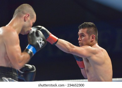 NOVOSIBIRSK, RUSSIA - NOVEMBER 29, 2014: Match Romero Marin (right) Of Mexico Vs Abdelkader Chadi Of Algeria During AIBA Pro Boxing Tournament. The Winners Will Go To The Olympics-2016