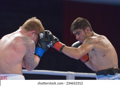 NOVOSIBIRSK, RUSSIA - NOVEMBER 29, 2014: Match Evaldas Petrauskas Of Lietuva (left) Vs Carlos Aquino Of Argentina During AIBA Pro Boxing Tournament. The Winners Will Go To The Olympics-2016