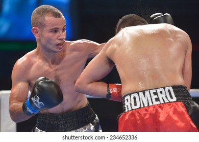 NOVOSIBIRSK, RUSSIA - NOVEMBER 29, 2014: Match Romero Marin (right) Of Mexico Vs Abdelkader Chadi Of Algeria During AIBA Pro Boxing Tournament. The Winners Will Go To The Olympics-2016