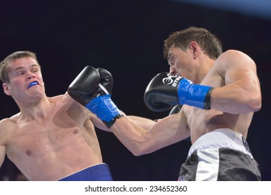 NOVOSIBIRSK, RUSSIA - NOVEMBER 29, 2014: Match Boris Georgiev (right) Of Bulgaria Vs Viacheslav Kislitsyn Of Ukraine During AIBA Pro Boxing Tournament. The Winners Will Go To The Olympics-2016