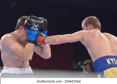 NOVOSIBIRSK, RUSSIA - NOVEMBER 29, 2014: Match Boris Georgiev (left) Of Bulgaria Vs Viacheslav Kislitsyn Of Ukraine During AIBA Pro Boxing Tournament. The Winners Will Go To The Olympics-2016