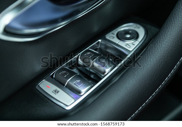 Novosibirsk, Russia – October 10, 2019: \
Mercedes-Benz E-class, Close up of a door control panel in a new\
modern car. Arm rest with window control panel, door lock button,\
and mirror\
control.\
