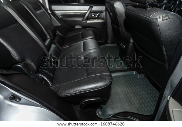 Novosibirsk, Russia – October 13, 2019: \
Mitsubishi Pajero,  close-up of the black  leather rear seats with\
seats belt. modern car\
interior\
