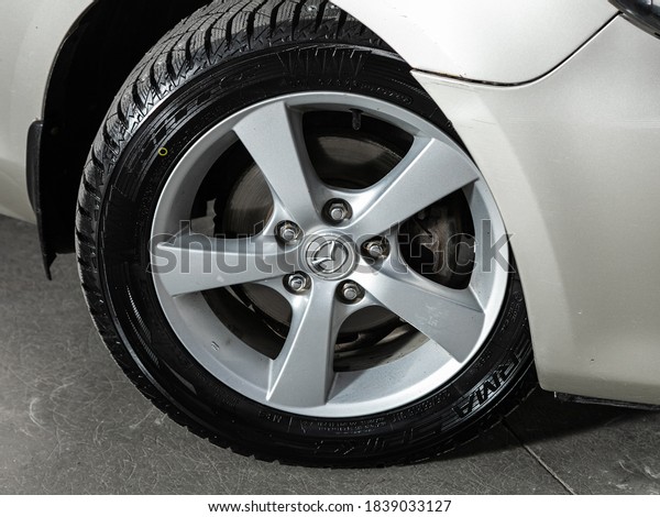 Novosibirsk, Russia – October 16, 2020: Mazda 3,\
Car wheel with alloy wheel and new rubber on a car closeup. Wheel\
tuning disc\
