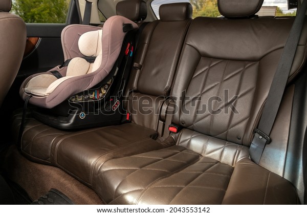 Novosibirsk, Russia - September 12, 2021: \
Infiniti  FX 37,close-up of the black  rear seats with baby car\
seat and  seats belt. modern car\
interior\
