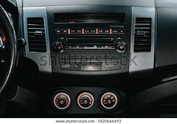Novosibirsk, Russia – September 19, 2020:\
Mitsubishi Outlander, close-up of the central control panel,\
monitor with music and radio , adjustment of the blower, air\
conditioner, player.  car\
interior