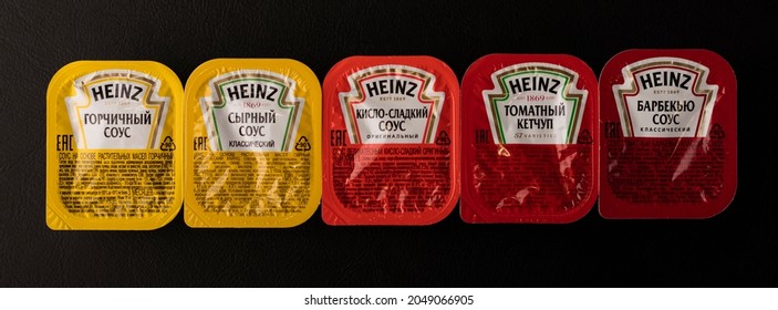 Novosibirsk, Russia - September 5, 2021 - A Set Of Heinz Sauces In A Package On A Black Table. Top View. American Food Company, Renowned Ketchup Manufacturer