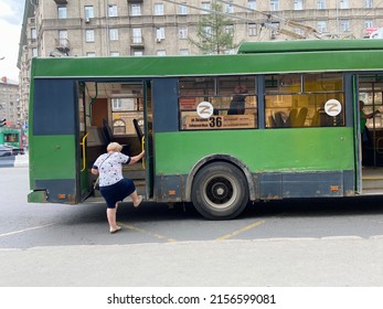 NOVOSIBIRSK, RUSSIA-15 May 2022:  Public transport of the city of Novosibirsk. An elderly passenger gets on a trolleybus