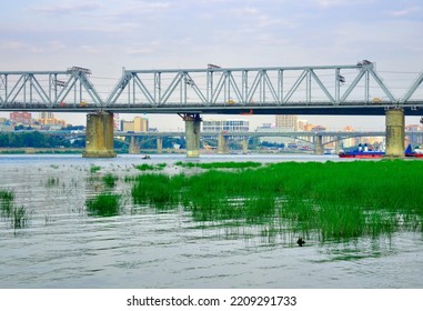 Novosibirsk, Siberia, Russia, 08.20.2022. The Capital Is On The Ob. Railway Bridge Of The Trans - Siberian Railway Over The Waters Of The River