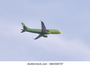 Novosibirsk, Siberia, Russia-07.25.2020: Green Plane In The Blue Sky. The Airliner Of S7 Airlines