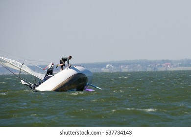 NOVOSIBIRSK,RUSSIA-JULY12:Sailing Regatta, Inter-regional Competition To Support Children's Sailing Siberiariver-2015, Sinking Yacht, July12, 2015 In Novosibirsk, Russia