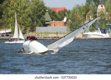 NOVOSIBIRSK,RUSSIA-JULY12:Sailing Regatta, Inter-regional Competition To Support Children's Sailing Siberiariver-2015, Sinking Yacht, July12, 2015 In Novosibirsk, Russia