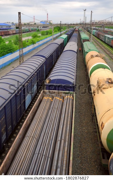 Novosibirsk/Siberia/Russia-05.29.2020: Cars at\
the railway station. Top view of railway freight trains to the\
horizon, wagons, tanks, a section of the TRANS-Siberian railway,\
main\
transport