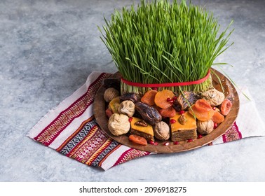 Novruz setting table decoration,  wheat grass, Azerbaijan national pastry pakhlava, new year sring celebration, nature awakening