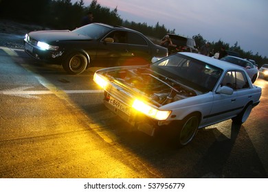 NOVYY URENGOY, RUSSIA - AUGUST 12, 2016: Motor Cars Nissan Laurel And Toyota Mark II Takes Part In The Night Street Drag Racing.