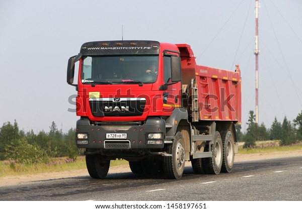 Novyy Urengoy, Russia - July 20,\
2019: Red dump truck MAN TGS 40.440 at the interurban\
road.