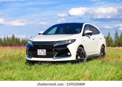 Novyy Urengoy, Russia - July 21, 2022: White Luxury Crossover Toyota Harrier In A Grass Field.