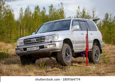 Novyy Urengoy, Russia - June 2, 2020: 4x4 car Toyota Land Cruiser 100 lifted with the Hi-Lift jack.