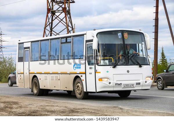 Novyy Urengoy, Russia - June\
25, 2019: White interurban coach KAvZ 4238 Avrora in the city\
street.