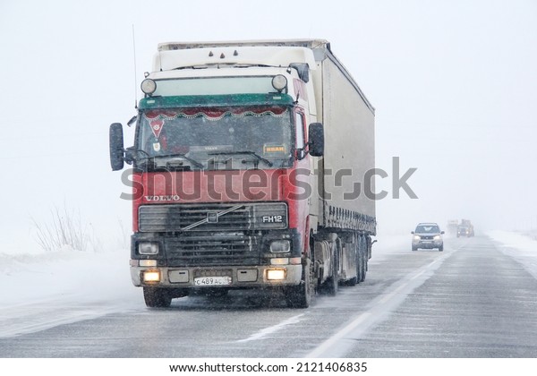Novyy Urengoy,\
Russia - March 2, 2014: Semi-trailer truck Volvo FH12 at an\
interurban road during a\
snowfall.