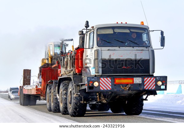 NOVYY URENGOY, RUSSIA -
MARCH 9, 2013: Heavy semi-trailer truck MZKT Volat at the
interurban road.