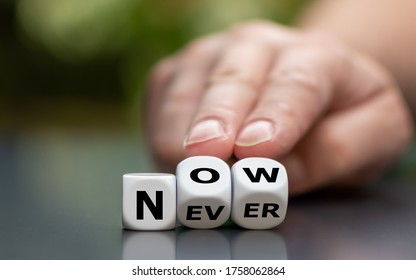 Now or never? Hand turns dice and changes the word "never" to "now".