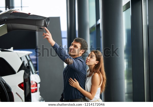 Now her\
dream comes true. Successful husband and his loving fashionable\
wife examine the trunk of recently purchased\
car.