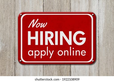Now hiring apply online red sign message on weathered wood 