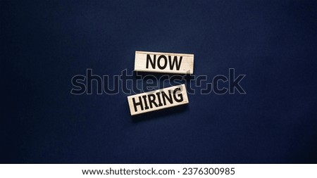 Now hiring symbol. Concept words Now hiring on beautiful wooden block. Beautiful black table black background. Business marketing, motivational now hiring concept. Copy space.