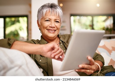 Now Ive Got More Time To Stream My Favorite Movies. Portrait Of A Happy Older Woman Relaxing On The Sofa With Her Digital Tablet At Home.