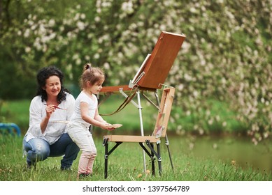 Now Let's Try What You Learned. Teaching Granddaughter How To Paint. In The Natural Parkland.